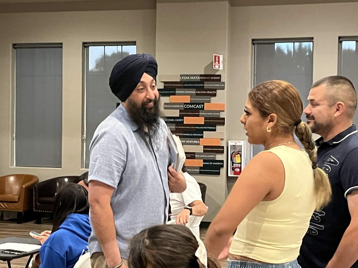 Central Unified trustee and Fresno City Council candidate Naindeep Singh, left, talks to attendees of a Sept. 28, 2026, forum in northwest Fresno.
